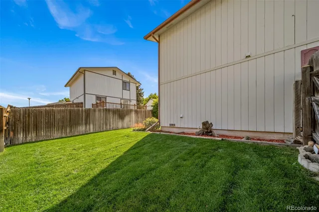 a view of a pathway of a wooden fence
