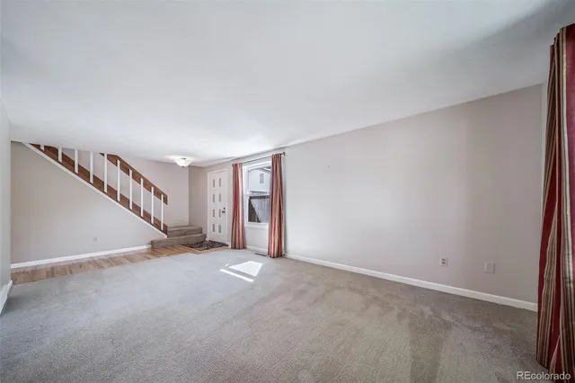 a view of an empty room with stairs