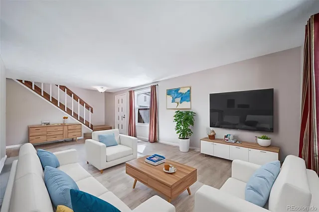 a living room with furniture and a flat screen tv