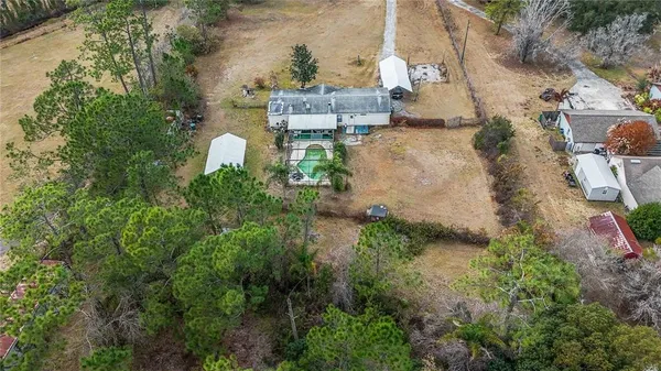 an aerial view of a house with a yard and lake view