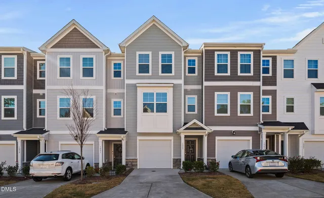 a front view of a residential apartment building with a yard