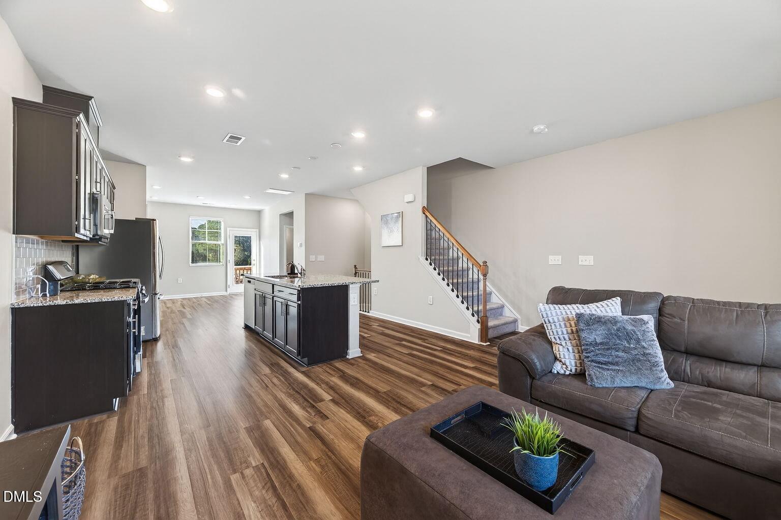 1063 Shoreside Drive Durham, NC 27713 - Photo 14 of 35 a living room with furniture and a wooden floor