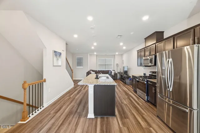 a view of a kitchen with a sink and refrigerator