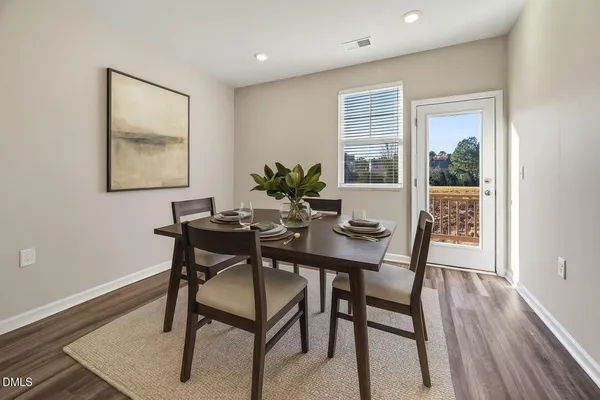a view of a dining room with furniture window and wooden floor