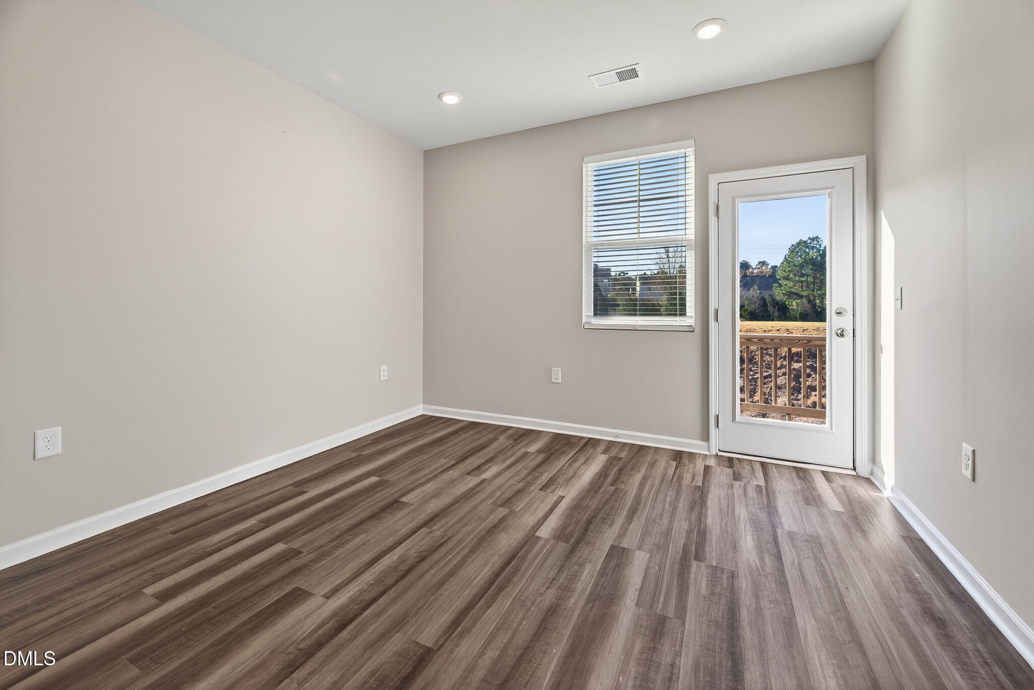 1063 Shoreside Drive Durham, NC 27713 - Photo 17 of 35 a view of an empty room with wooden floor and a window