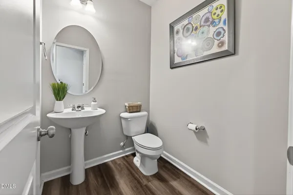 a bathroom with a toilet a sink and a mirror