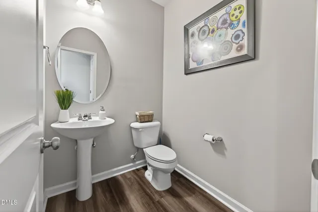 a bathroom with a toilet a sink and a mirror