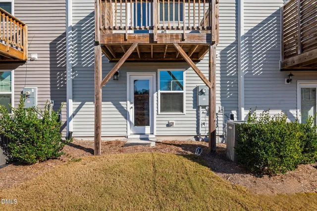 a view of a house with backyard and deck