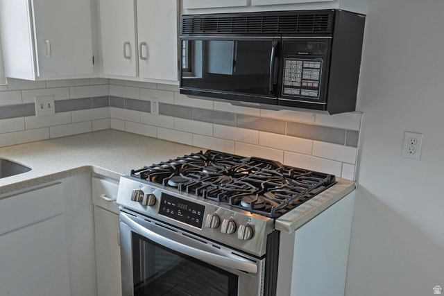 1722 Kimsbrough Road Sandy, UT 84092 - Photo 12 of 29 Kitchen featuring a stainless steel gas range with a coordinating over-the-range microwave