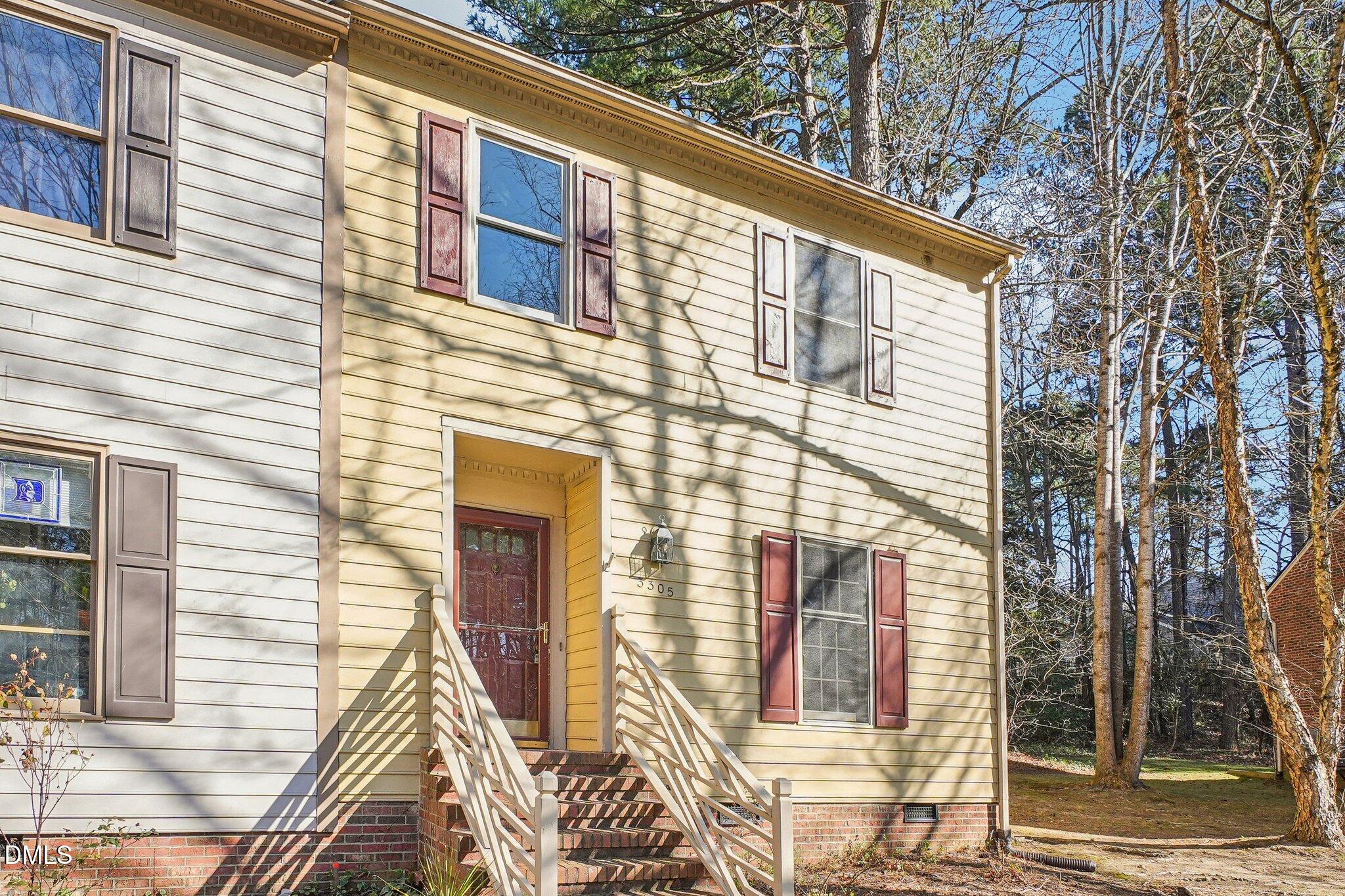 a view of a brick house with many windows