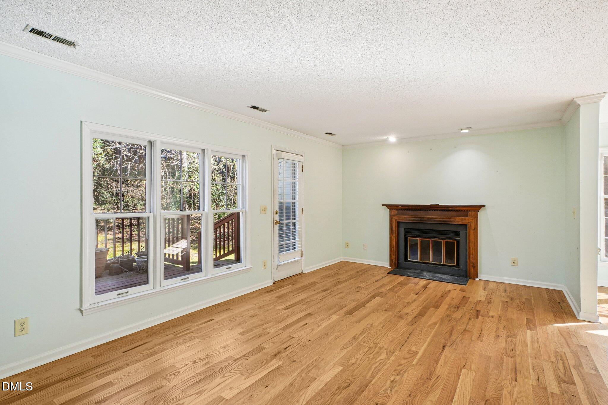 3305 Coachman's Way Durham, NC 27705 - Photo 10 of 35 a view of an empty room with wooden floor and a window