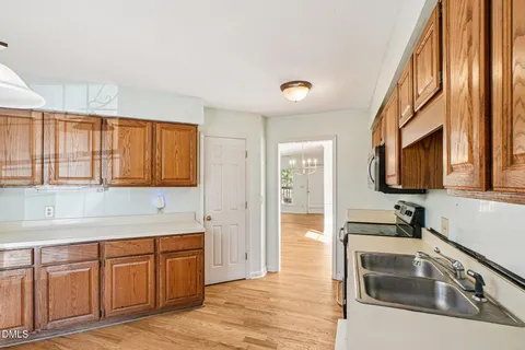 a kitchen with granite countertop a sink and a stove top oven