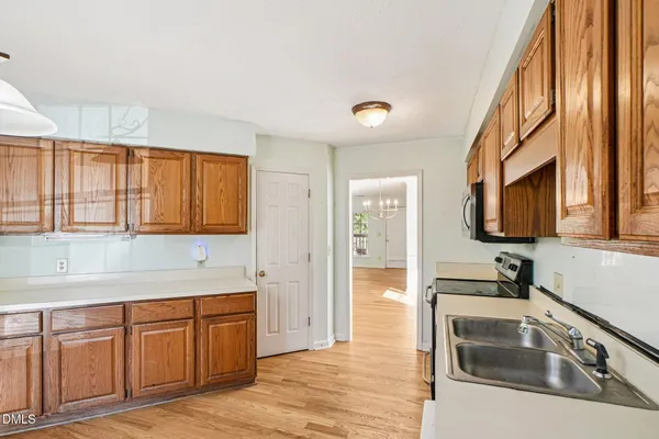 a kitchen with granite countertop a sink and a stove top oven