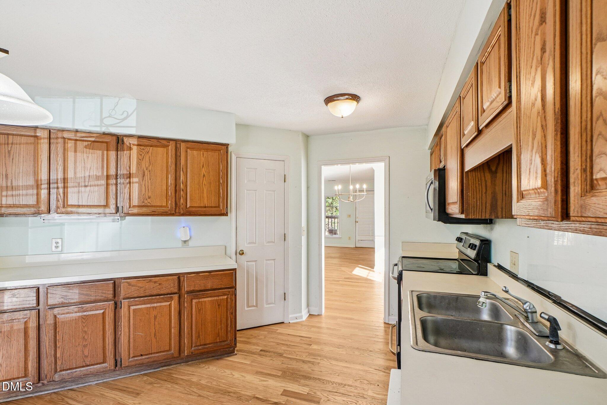 3305 Coachman's Way Durham, NC 27705 - Photo 14 of 35 a kitchen with granite countertop a sink and a stove top oven