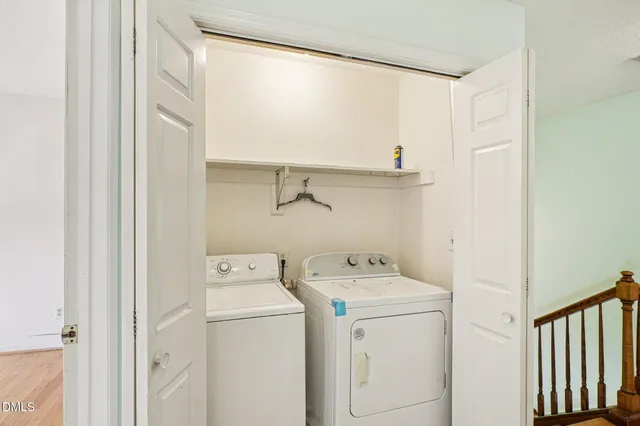an empty room with a window and a ceiling fan