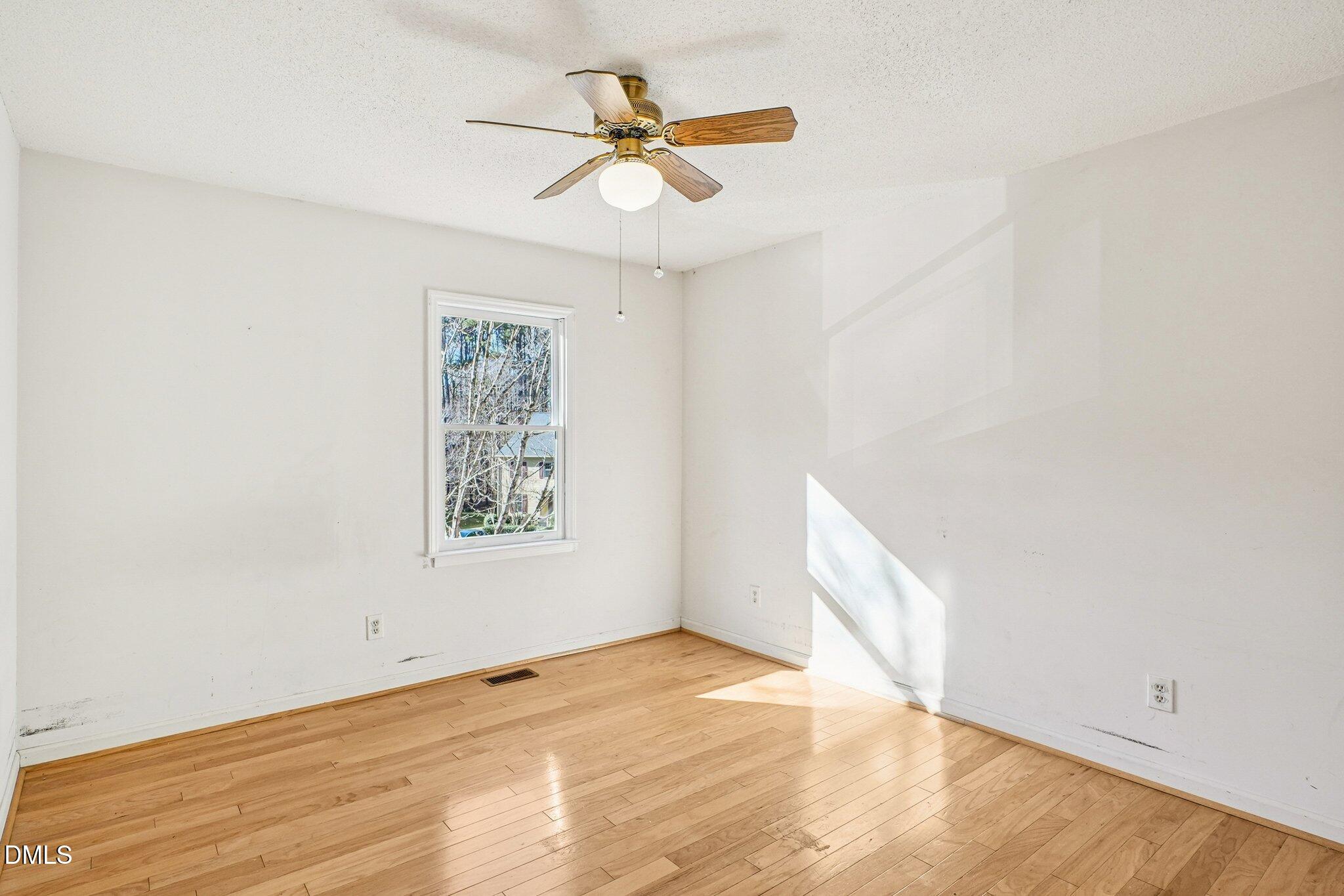 3305 Coachman's Way Durham, NC 27705 - Photo 24 of 35 an empty room with a window and a ceiling fan