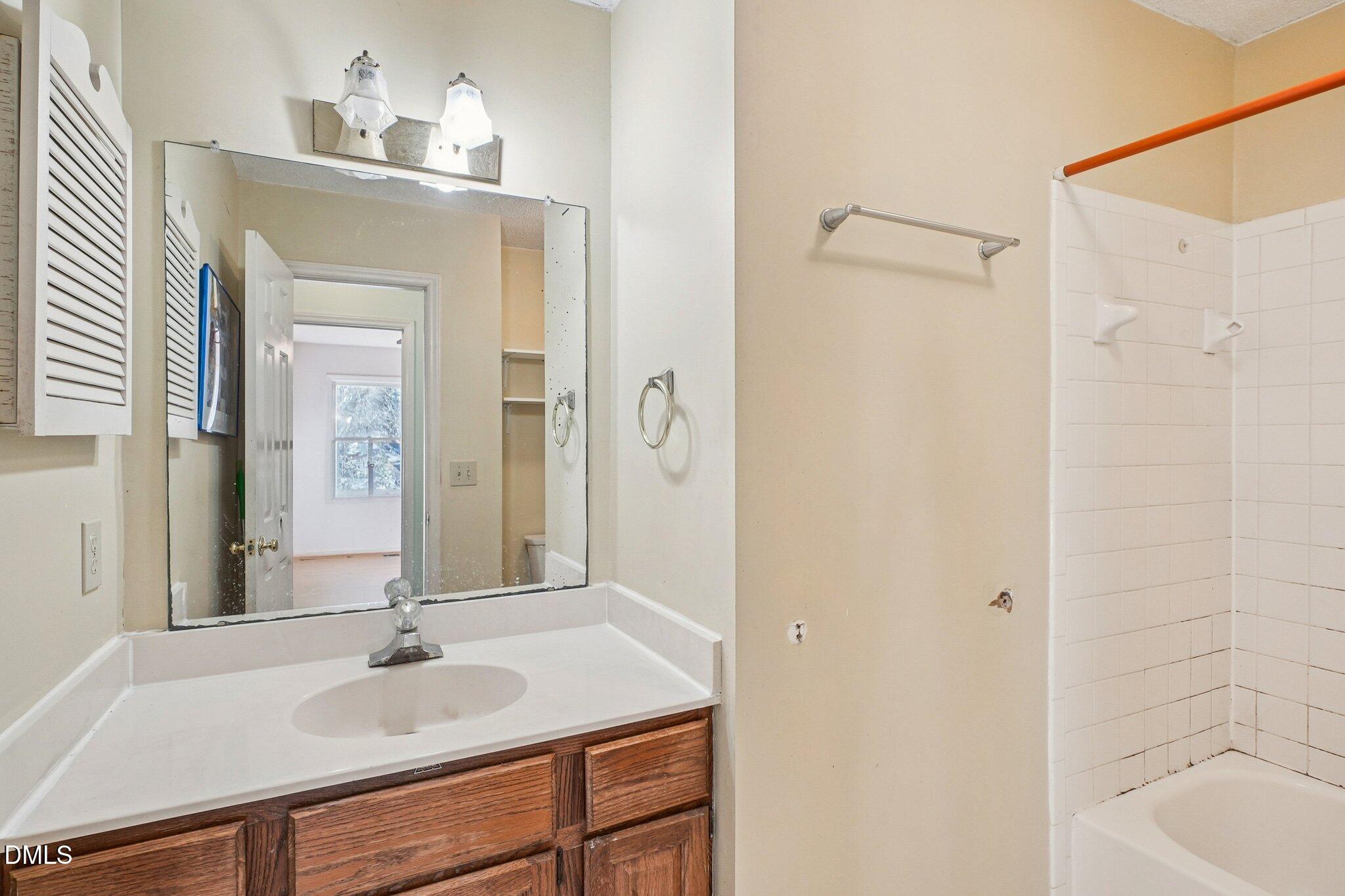 3305 Coachman's Way Durham, NC 27705 - Photo 29 of 35 a bathroom with a sink and a mirror