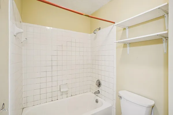 a bathroom with a shower and a toilet