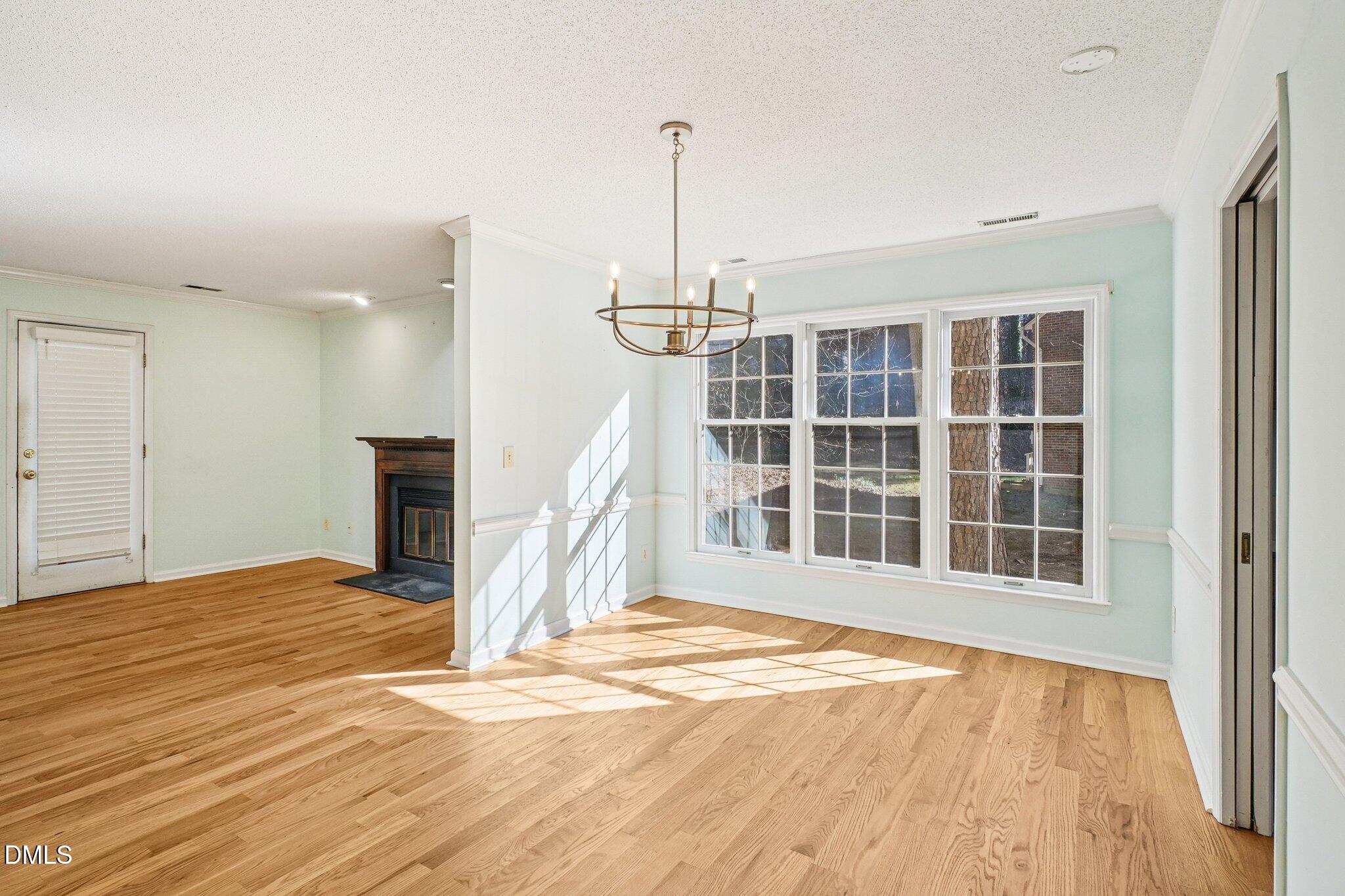 3305 Coachman's Way Durham, NC 27705 - Photo 4 of 35 a view of an empty room with a window and wooden floor