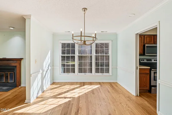 a view of a living room with wooden floor and windows