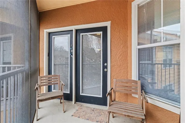 a living room with furniture kitchen view and a large window