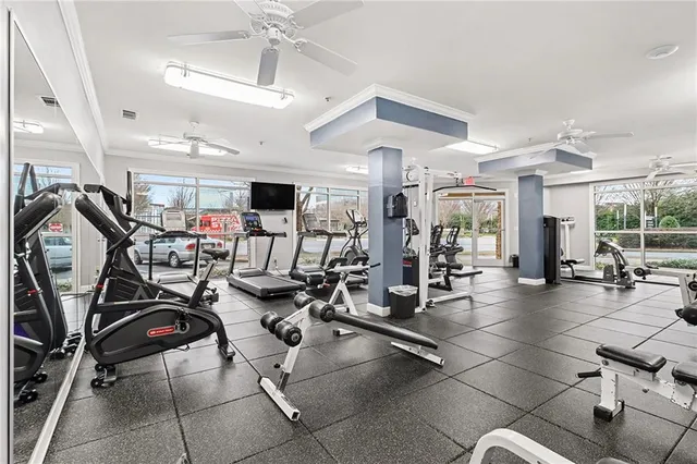 a view of a hallway with wooden floor and a living room