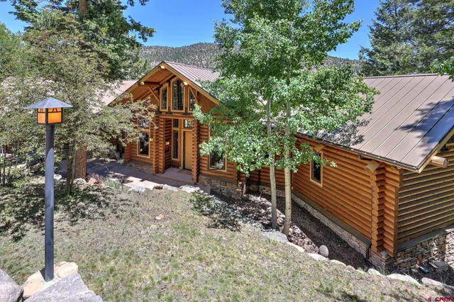 a front view of a house with trees