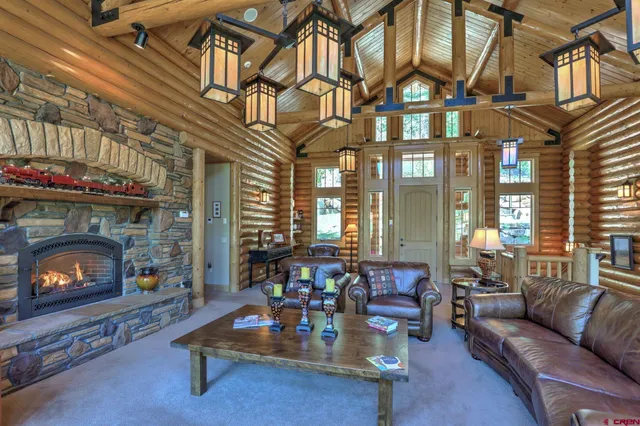 a living room with furniture fireplace and a large window