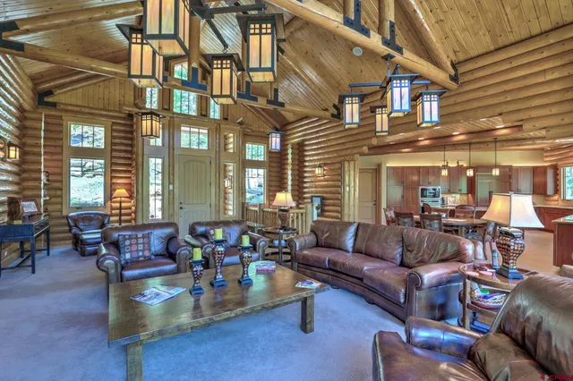 a living room with fireplace furniture and a large window