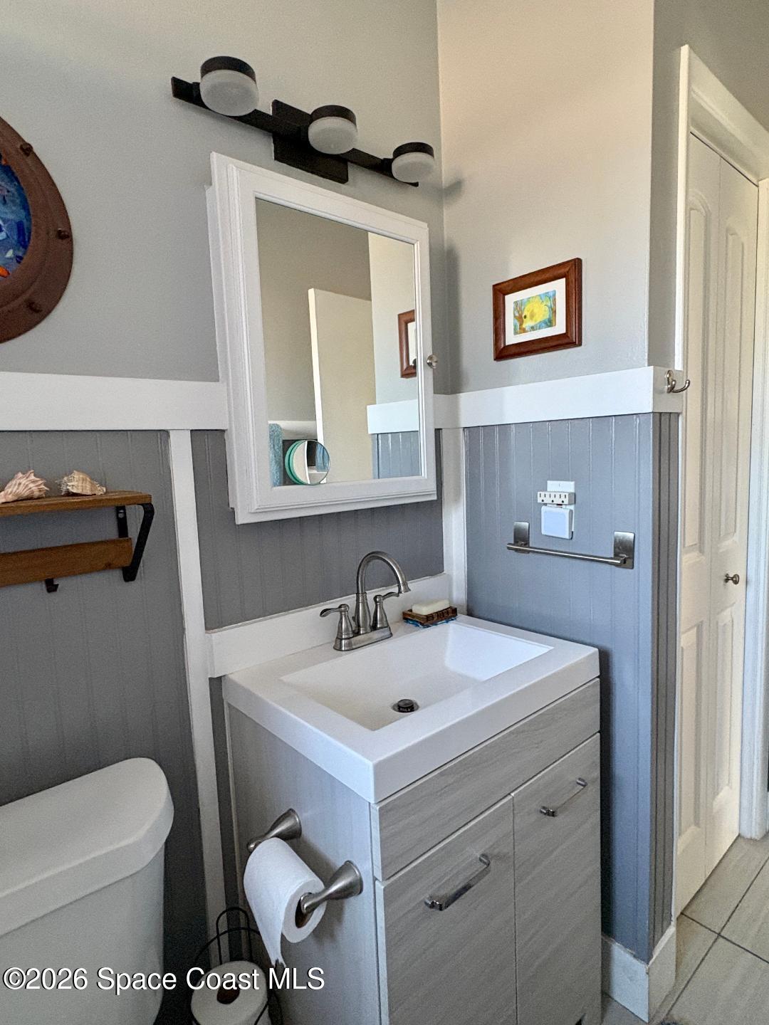 906 Santa Cruz Road Cocoa Beach, FL 32931 - Photo 16 of 24 a bathroom with a sink mirror and toilet