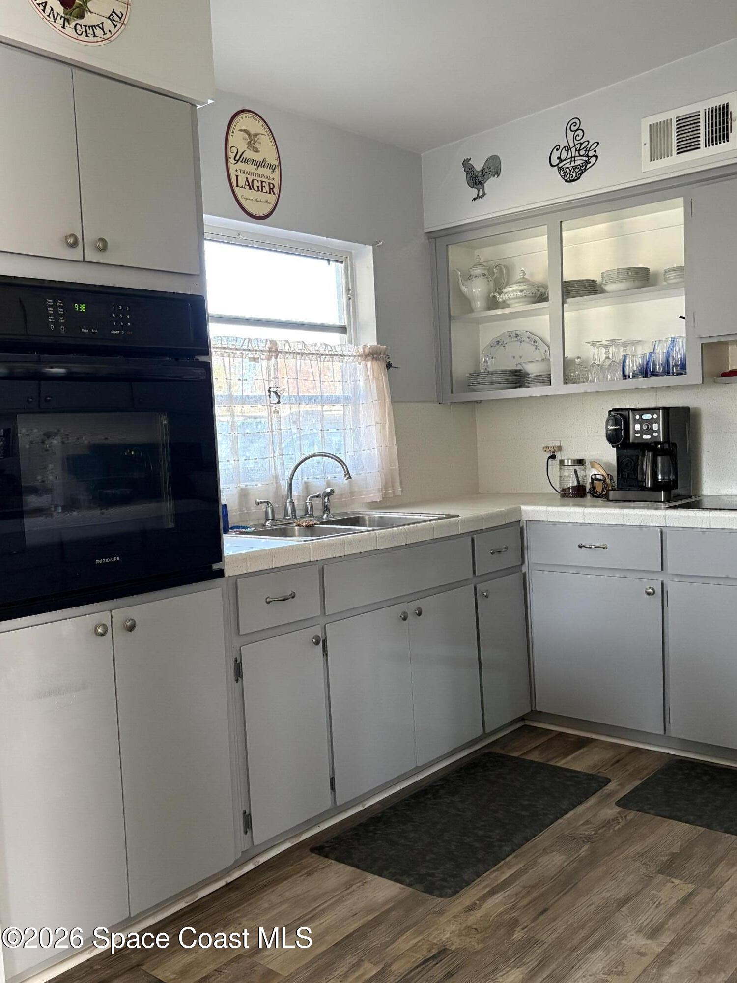 906 Santa Cruz Road Cocoa Beach, FL 32931 - Photo 6 of 24 a kitchen with a sink cabinets and window