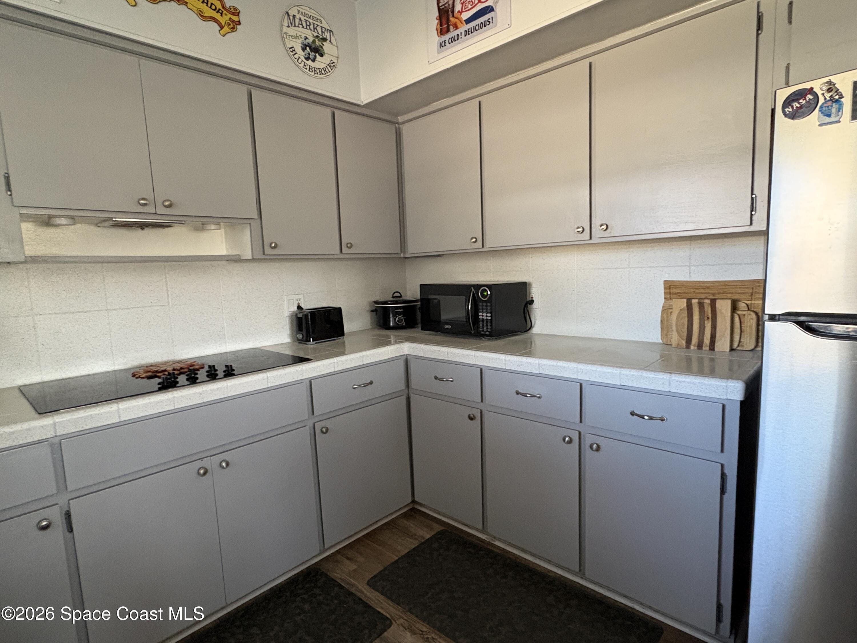 906 Santa Cruz Road Cocoa Beach, FL 32931 - Photo 7 of 24 a kitchen with cabinets appliances and a sink