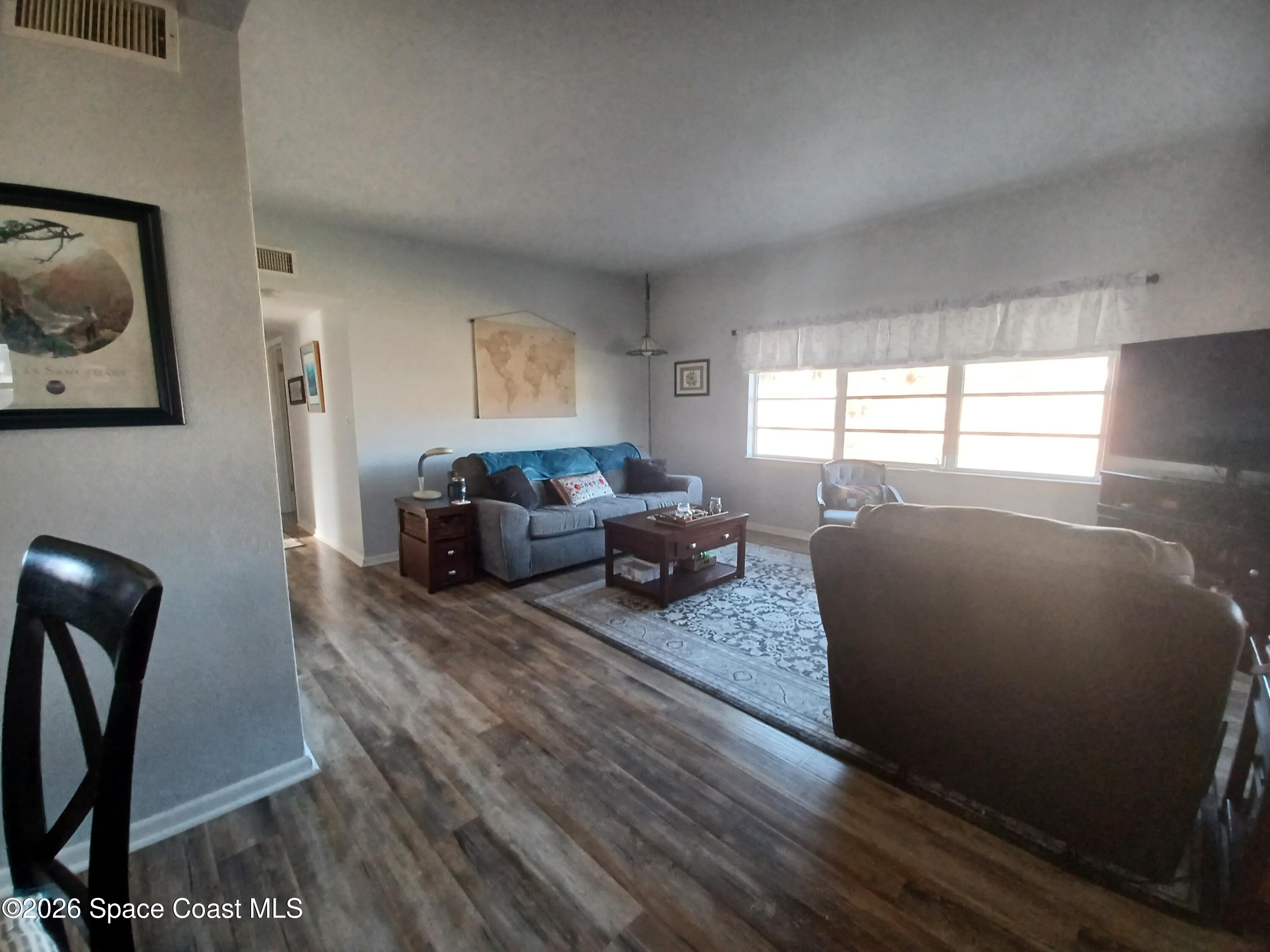 906 Santa Cruz Road Cocoa Beach, FL 32931 - Photo 9 of 24 a living room with furniture window and a wooden floor