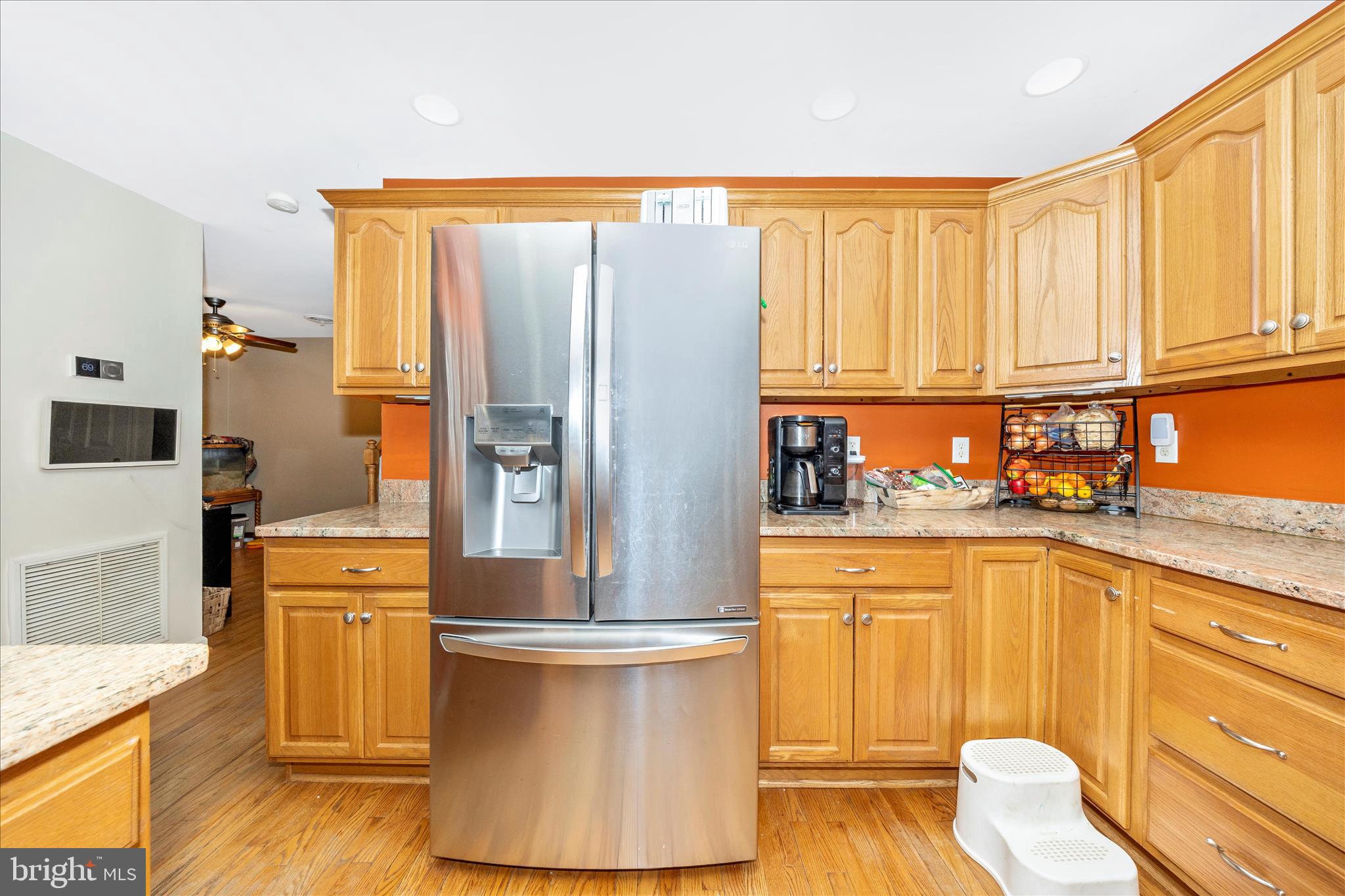 4120 Petersville Road Knoxville, MD 21758 - Photo 12 of 52 a kitchen with stainless steel appliances granite countertop a refrigerator a stove and white cabinets with wooden floor