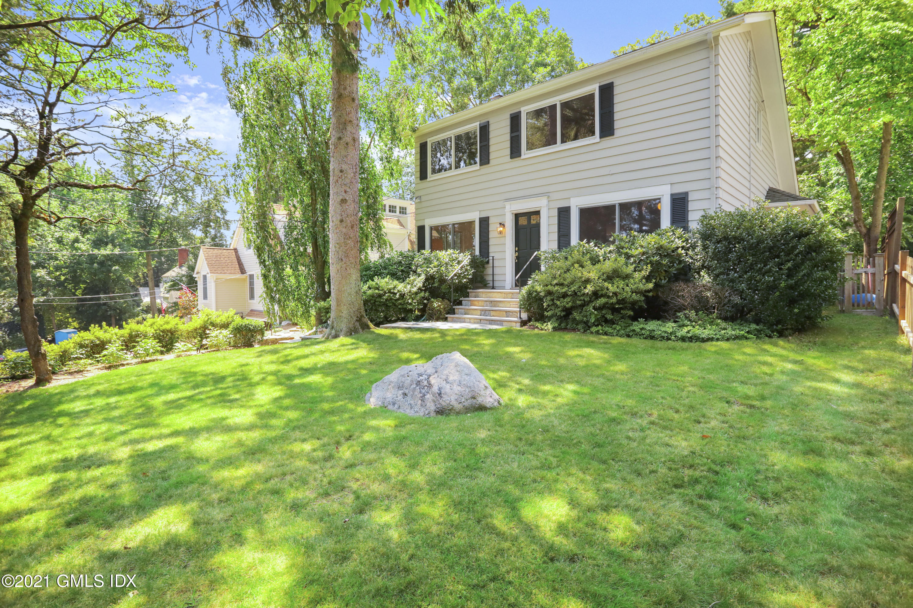 a front view of a house with garden