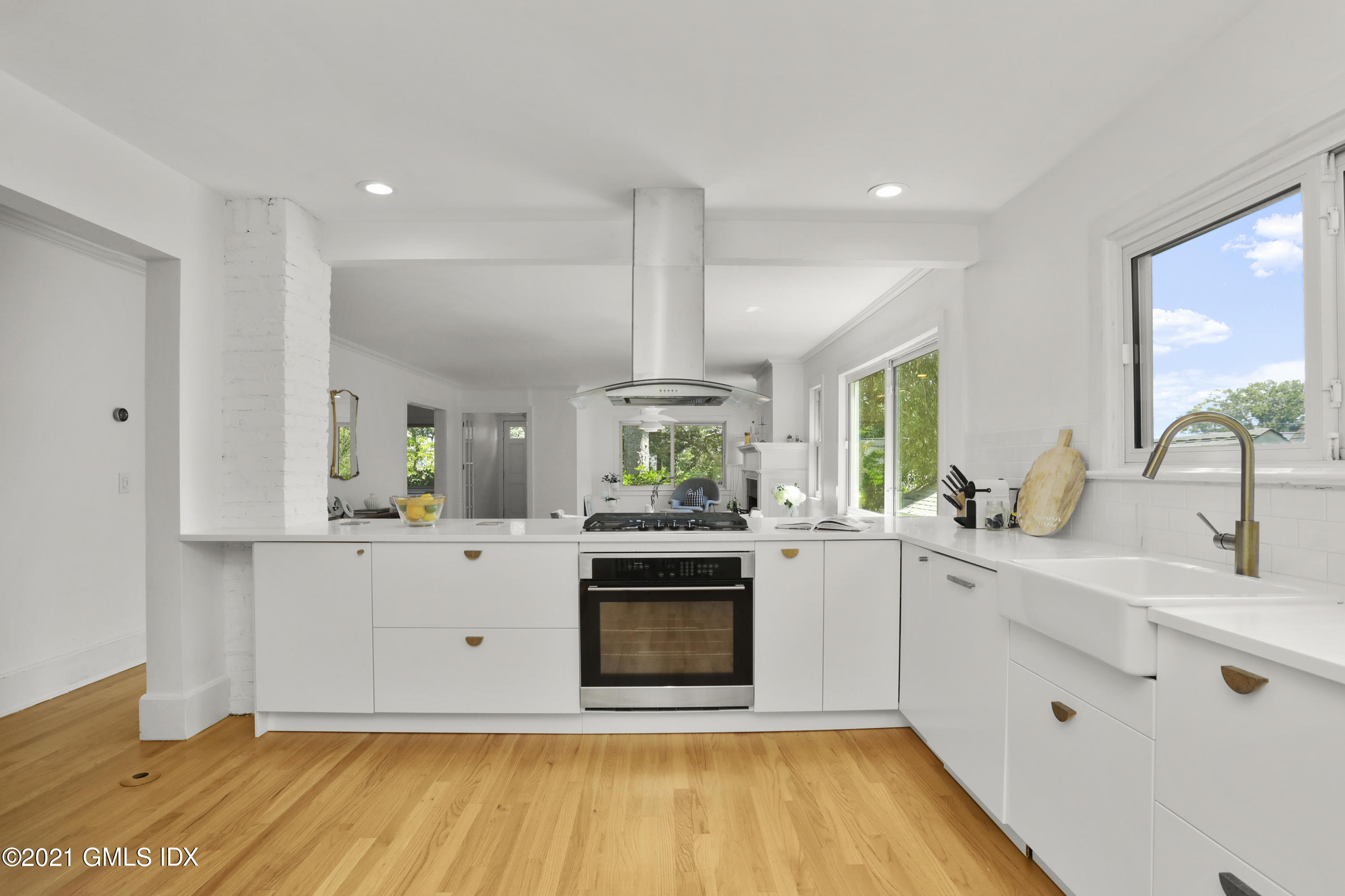 10 Ridge Road Cos Cob, CT 06807 - Photo 7 of 23 a kitchen with stainless steel appliances a stove a sink and a white wooden cabinets