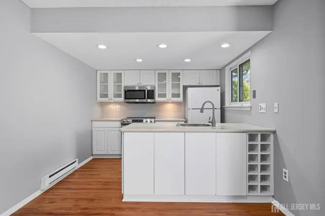 a kitchen with stainless steel appliances granite countertop a sink and cabinets