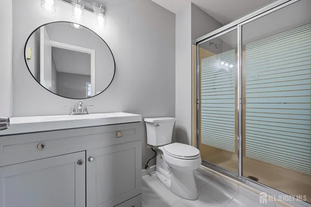 a bathroom with a toilet a sink and mirror