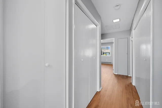 a view of a hallway with wooden floor