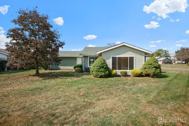 a view of a house with backyard and sitting area