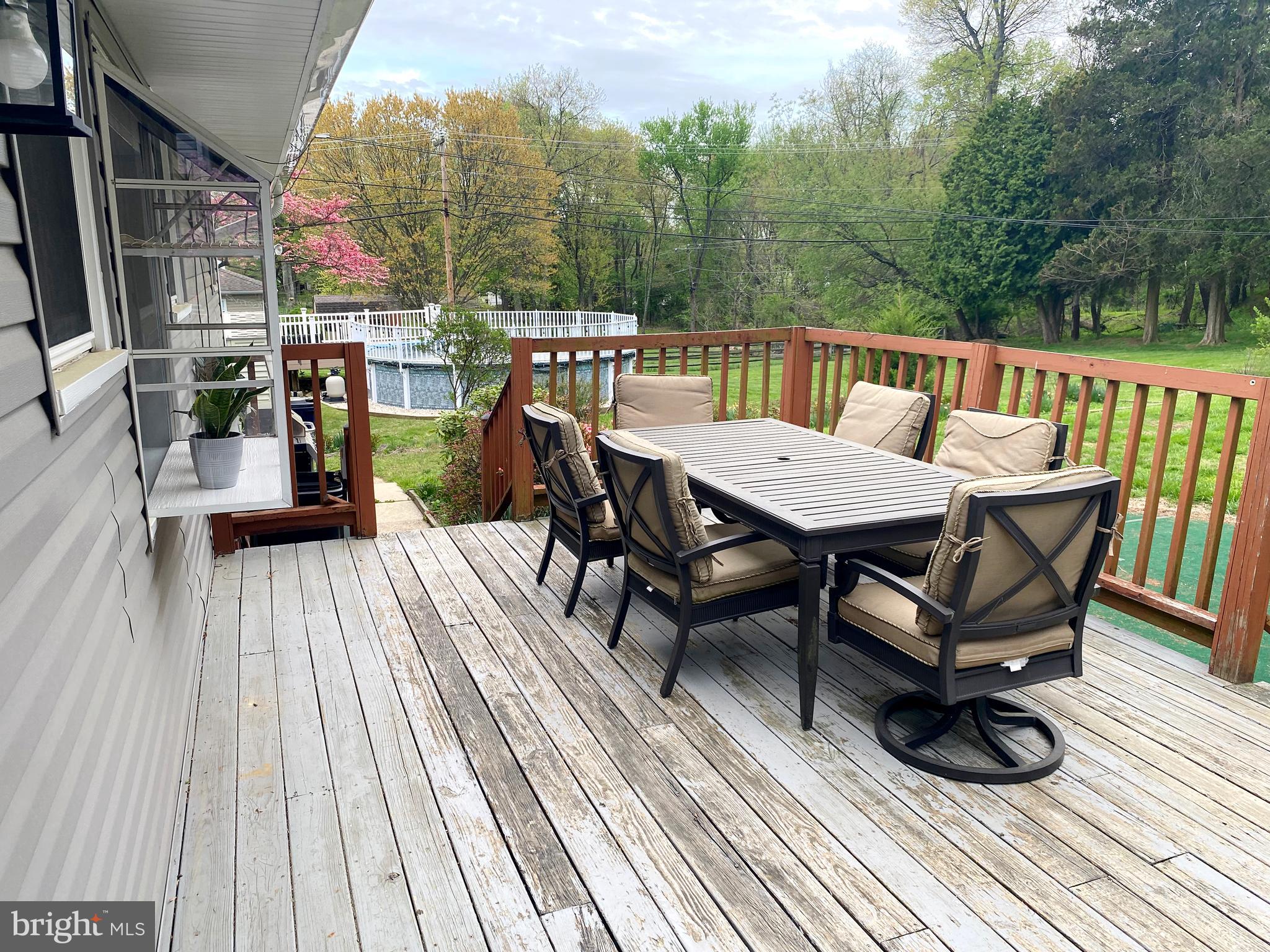 10 Tuscany Road Aston, PA 19014 - Photo 43 of 53 a view of a roof deck with table and chairs a barbeque with wooden floor and fence