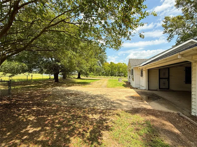 a view of swimming pool with a yard and trees