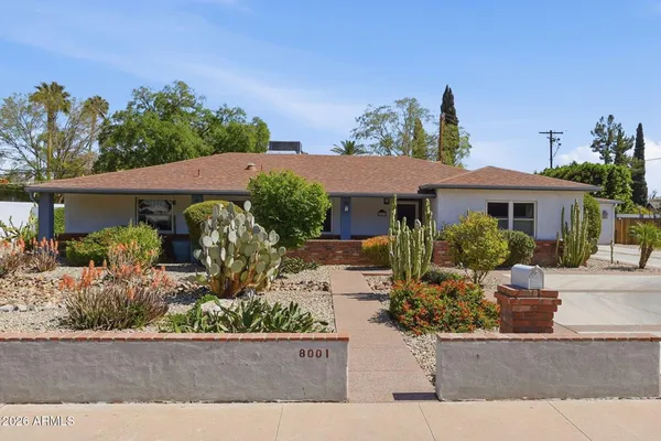 front view of a house with potted plants