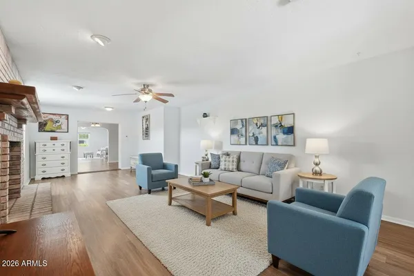 a living room with furniture and wooden floor