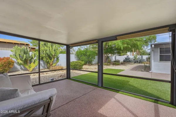 a backyard of a house with table and chairs