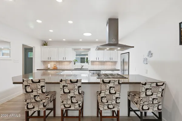 a kitchen with stainless steel appliances granite countertop a stove and a refrigerator
