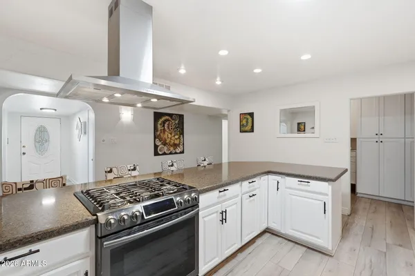 a kitchen that has a sink and a stove