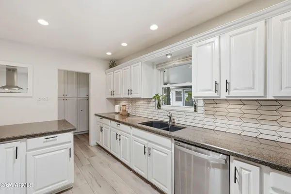 a kitchen that has a sink and cabinets