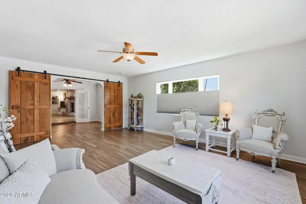 a living room with furniture and wooden floor