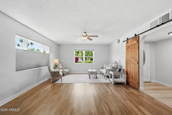 a living room with furniture and a wooden floor